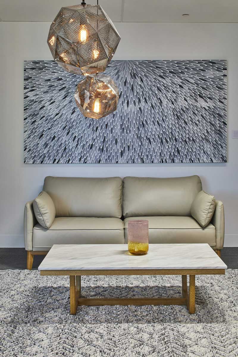 commercial interiors couch, lights and artwork