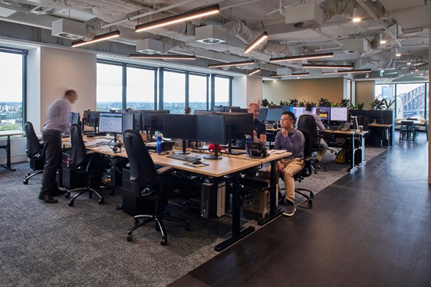 Trendy open plan office with employees at workstations